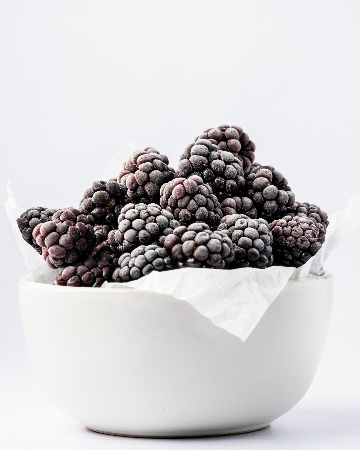 Frozen blackberries in a white bowl