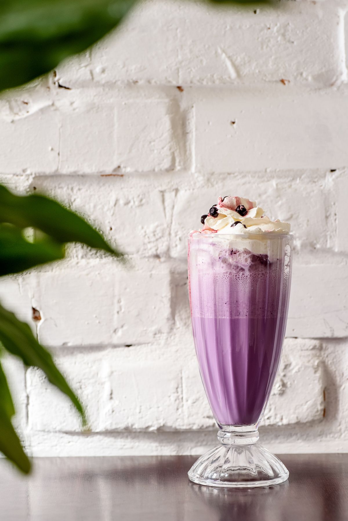 Blueberry milkshake with whipped cream and blueberries
