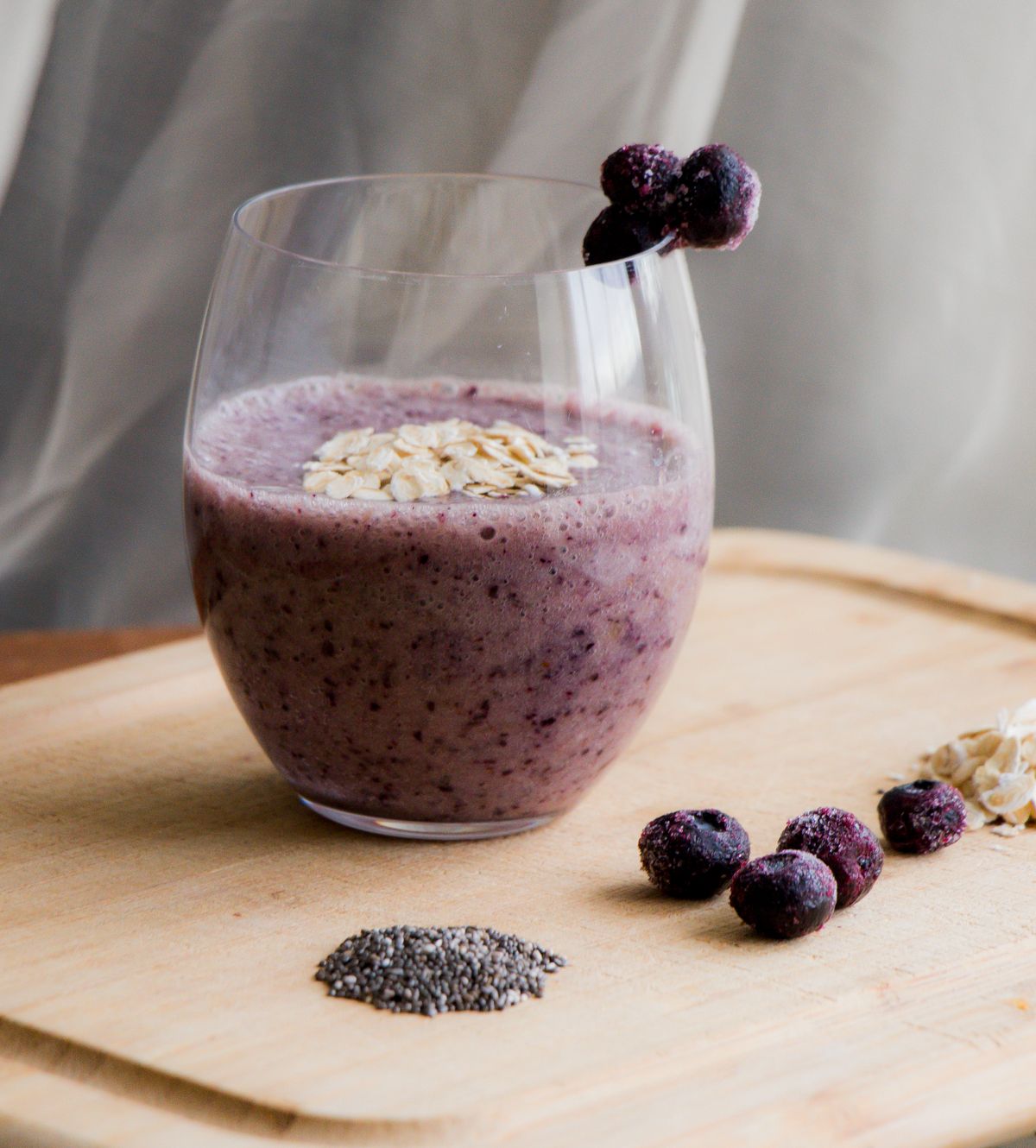Blueberry smoothie with oats in a clear glass