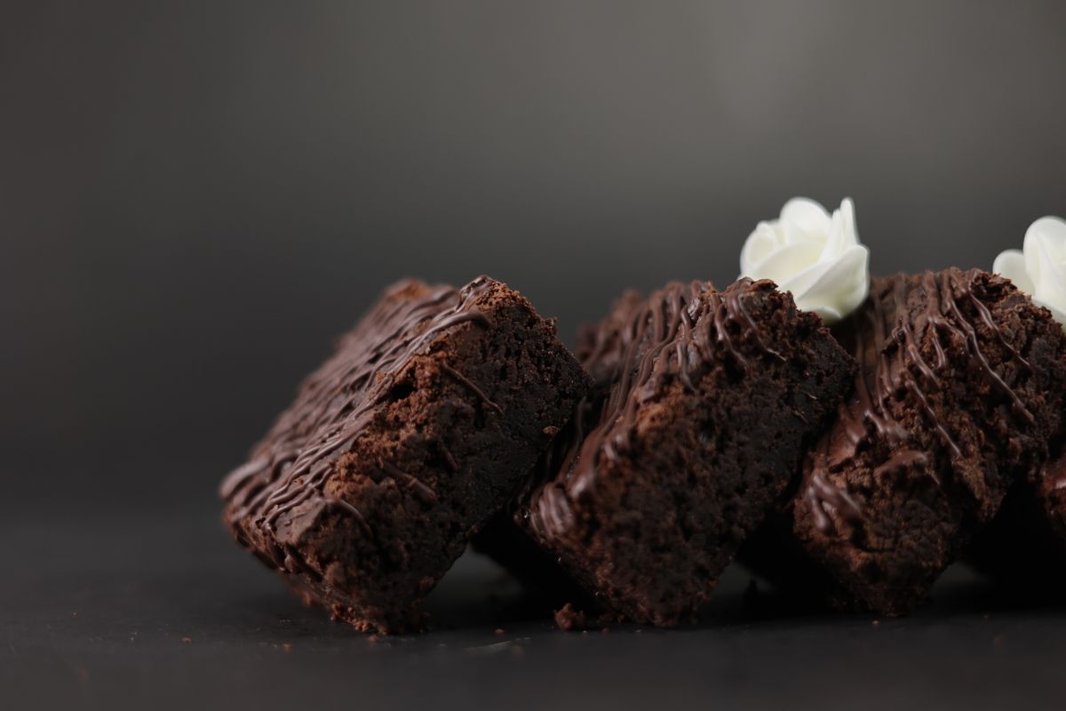 Chocolate brownies topped with a dollop of cream