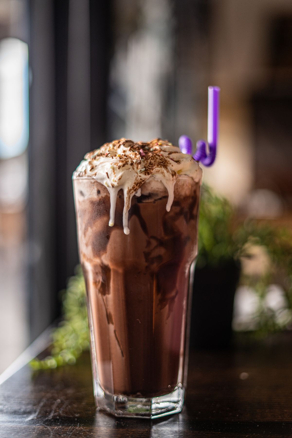 Iced chocolate drink with cream and chocolate flakes