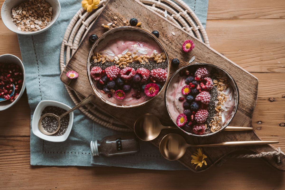 Berry smoothie bowls topped with raspberries, blueberries and granola