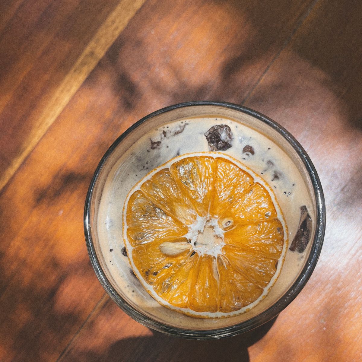 Iced black coffee with a slice of orange