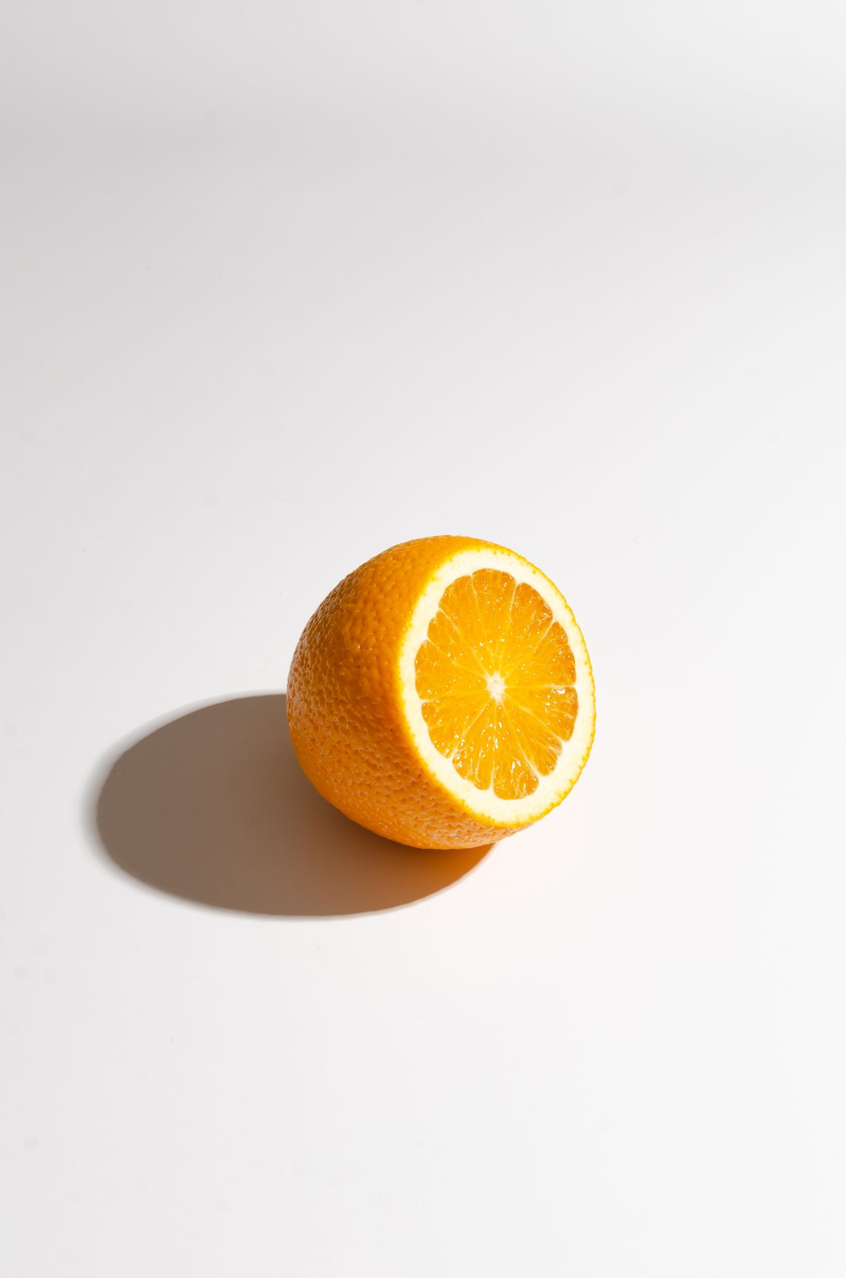 Fresh orange slice casting a shadow