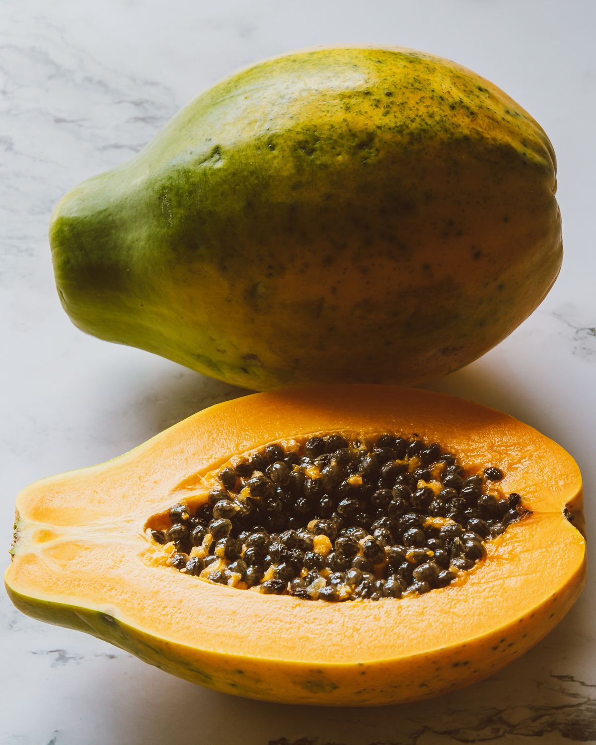 Ripe papaya cut open to show its seeds