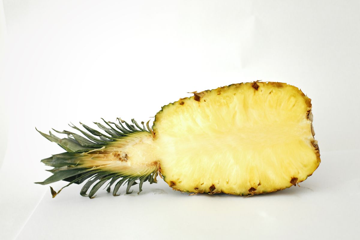Sliced pineapple on a pale surface
