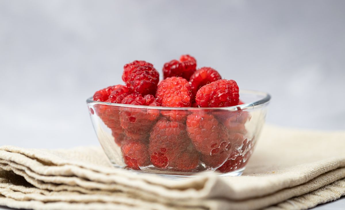 Fresh raspberries in a glass bowl