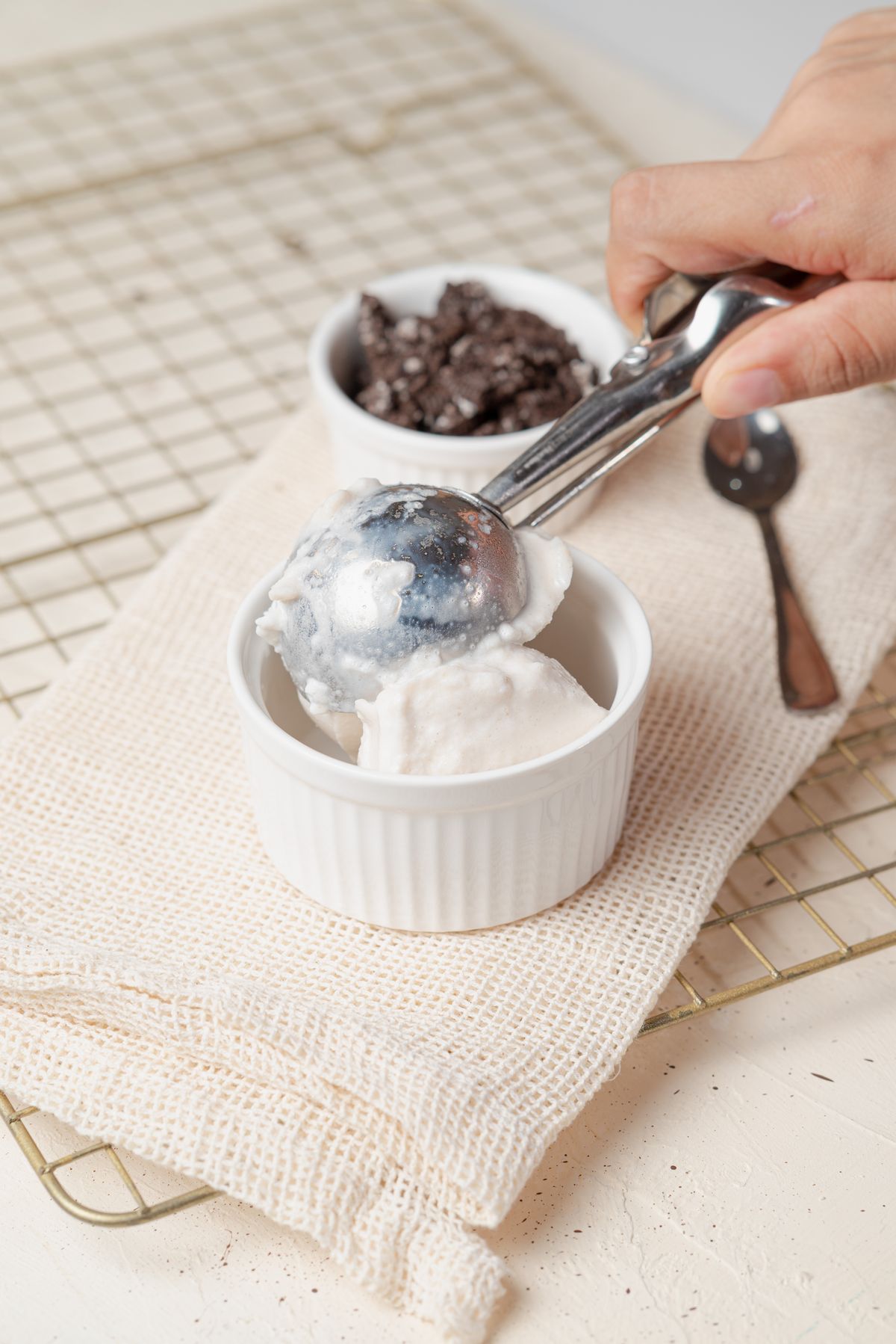 A spoon scooping soft vanilla ice cream