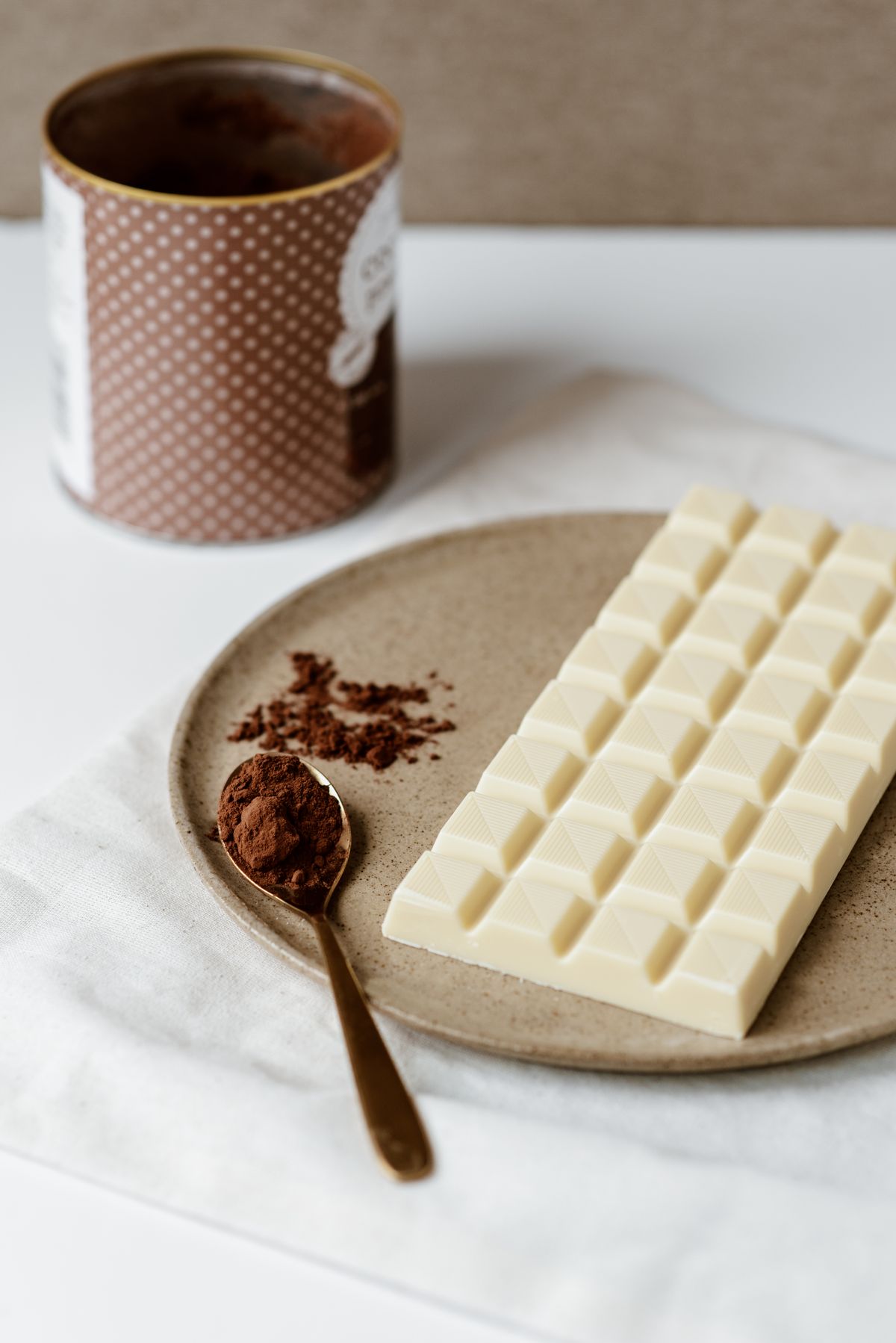 White chocolate with a spoon of cocoa powder