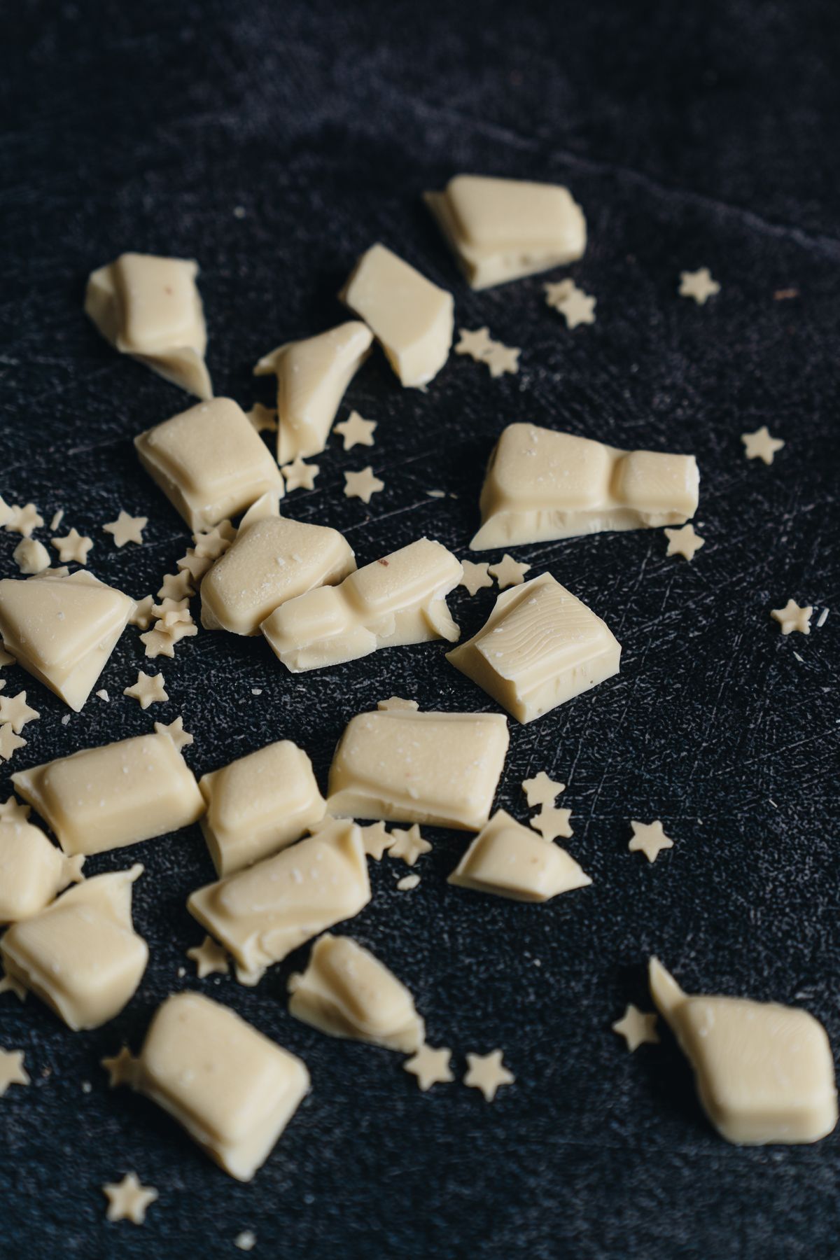 Pieces of white chocolate on a dark background